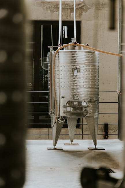Stainless steel fermentation tank in a modern industrial facility.